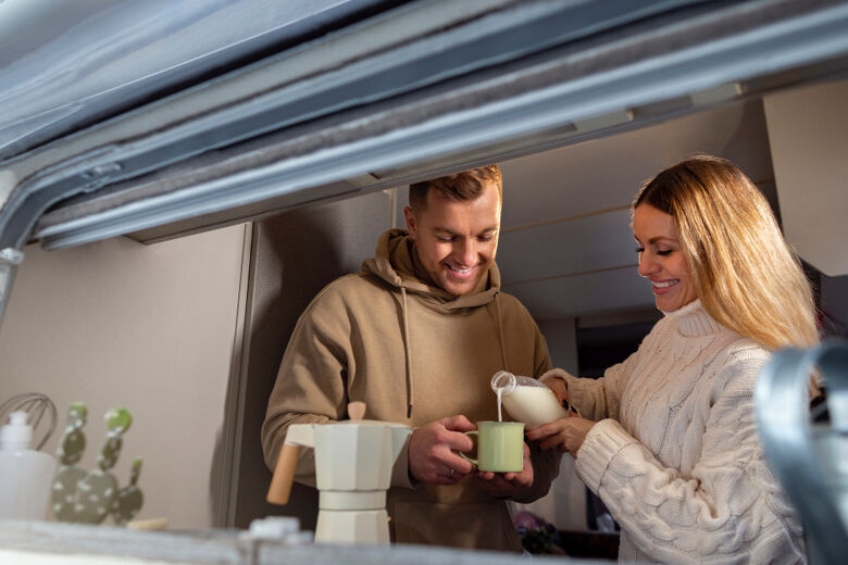 medium-shot-smiley-couple-campervan
