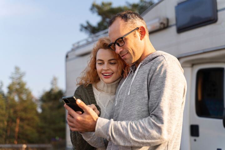medium-shot-smiley-couple-with-device
