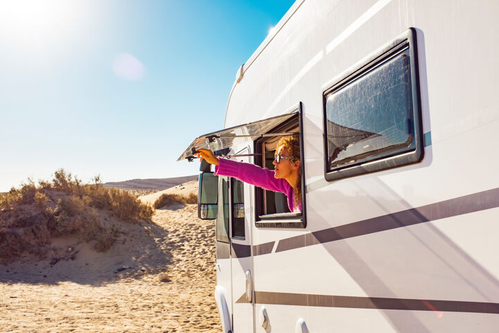 adult-tourist-woman-opening-camper-van-window-enjoy-sun-freedom-concept-travel-people-summer-holiday-vacation-inside-camping-car-motorhome-vehicle-freedom-nomad-lifestyle