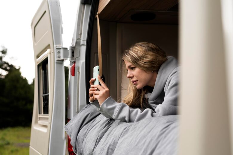 woman-relaxing-her-camper-daylight