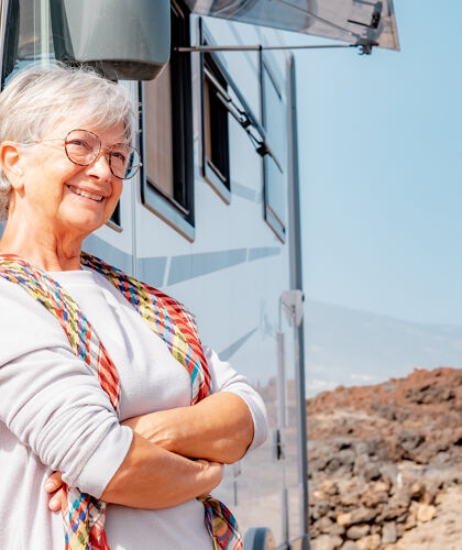 happy-retired-senior-woman-outdoor-her-camper-van-vehicle-enjoying-free-vacation-travel (1)